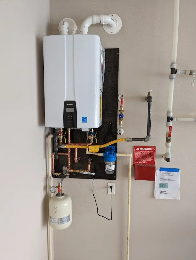 Professional plumber installing copper piping in a Poinciana home